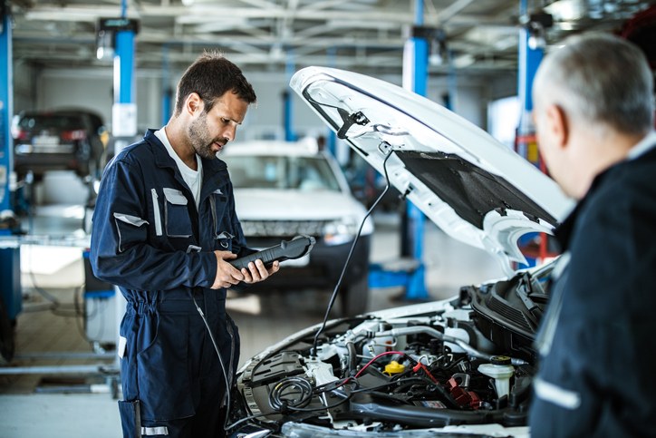 worker mercedes benz inspecting at showroom